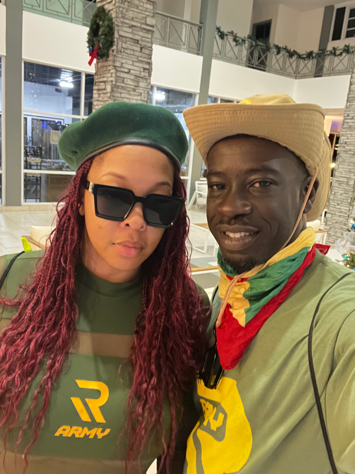 Shawn and Daimon in Grenadian-themed attire wearing hats and Grenada colors